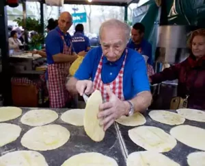 Man preparing food at Santo Tomas Market