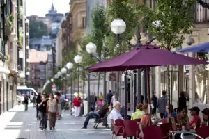 A street with outside terrace for bars and people walking