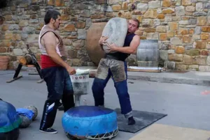 Stone lifters - Basque games at picturesque txakoli winery in Biscay