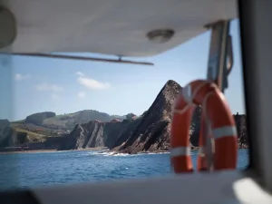 view of the coast from a boat with a lifebuoy visible