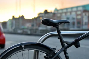 Bicycle saddle and part of frame  on a bridge with the river out of focus behind